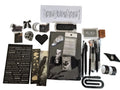 A flat-lay display of a gothic-themed stationery  Bundle includes a black book light, a white sheet of black letter stickers, a black heart-shaped corner page holder, pens, washi tape, a rubber ink stamp, ink pad and various other gothic-themed accessories