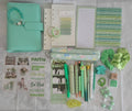 A coordinated stationery and accessory flat lay in soft mint green, white, and pastel tones, including a mint planner or notebook, pens, sticky notes, stickers, rings, scrunchies, and small decorative items.