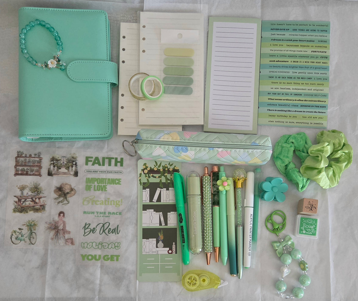A coordinated stationery and accessory flat lay in soft mint green, white, and pastel tones, including a mint planner or notebook, pens, sticky notes, stickers, rings, scrunchies, and small decorative items.